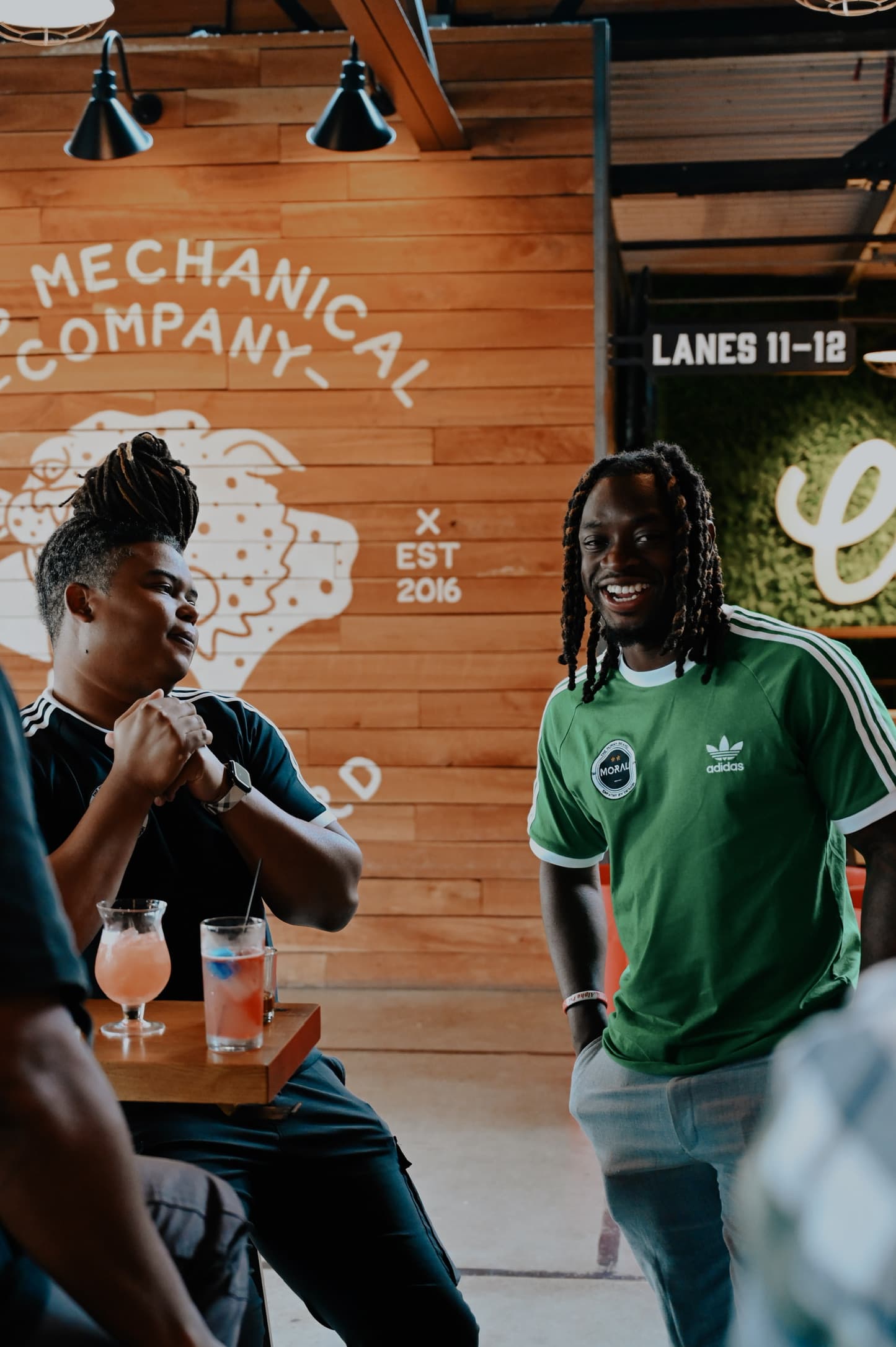 Nick Okoro laughing with a colleague at a team gathering